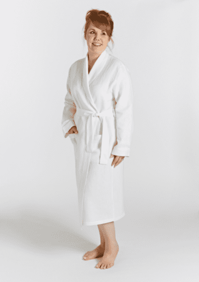 Woman posing in white bathrobe with hand in pocket